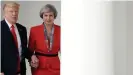  ??  ?? Donald Trump and Theresa May awkwardly hold hands at White House – video