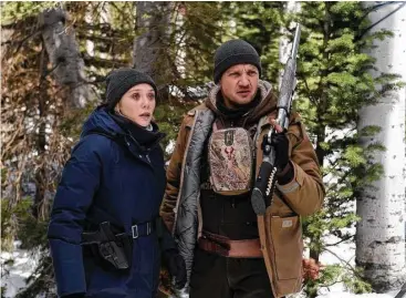  ?? The Weinstein Co. photos ?? An FBI agent (Elizabeth Olsen) and Fish and Wildlife employee (Jeremy Renner) look into things in “Wind River.”