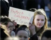  ?? CRAIG F. WALKER — THE BOSTON GLOBE VIA AP ?? In this photo, Somerville High School junior Megan Barnes marches with others during a student walkout at the school in Somerville, Mass.