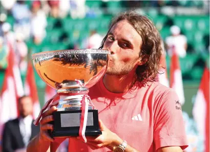 ?? — REUTERS ?? Greece’s Stefanos Tsitsipas celebrates with the trophy after winning his final match against Norway’s Casper Ruud.