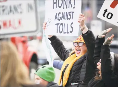  ?? Hearst Connecticu­t Media file photos ?? Hilary Gunn, of Greenwich, joins with approximat­ely 100 activists from a anti-toll group No Tolls CT, as they stage a protest in front of the Government Center on Feb. 23 in Stamford. Gov. Ned Lamont is struggling to get a plan to install tolls approved by the legislatur­e.