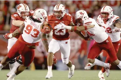  ?? GETTY IMAGES ?? Wisconsin’s Jonathan Taylor (221 yards, three TDs) led a ground game that sent Nebraska to its ninth consecutiv­e loss.