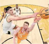  ?? GREGORY SHAMUS GETTY IMAGES ?? Purdue’s Zach Edey blocks a shot by Tennessee’s Dalton Knecht on Sunday.