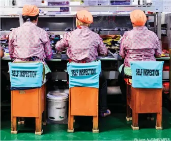  ??  ?? Picture: ALASTAIR WIPER Low pay: Workers in an Adidas factory in Indonesia. The firm made profits of £1.87bn last year
