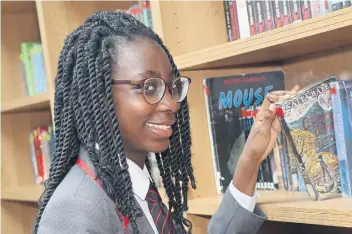  ?? ?? Sarah Dada, 13, took on the ‘readathon’ challenge to raise money for the charity Christian Aid.