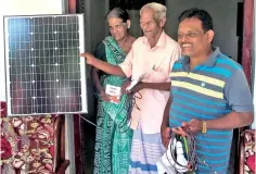  ??  ?? A Spice farmer with a solar panel donated by a MA’s Kitchen customer.