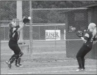  ?? The Sentinel-Record/Grace Brown ?? JUST OUT OF REACH: Fountain Lake’s Bailey Helton (14) attempts to catch a ball as teammate Hannah Vaughn (6) looks on during Monday’s 18-1 loss to Malvern Monday.