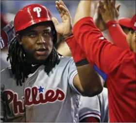  ?? BRYNN ANDERSON — THE ASSOCIATED PRESS ?? Philadelph­ia Phillies’ Maikel Franco celebrates with teammates after scoring a run during the fourth inning of a baseball game against Miami Marlins, Sunday in Miami.