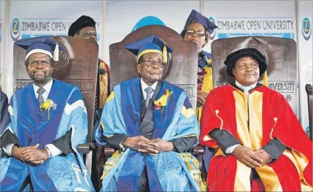  ?? Ben Curtis Associated Press ?? PRESIDENT ROBERT MUGABE, center, attends a university graduation Friday in Harare, Zimbabwe, his first public appearance since the military placed him under house arrest this week. His support within his ruling ZANU-PF party continues to collapse.