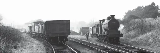  ?? W S Sellar ?? Rated as ‘3F’ and a long-term Dalry Road engine, Pickersgil­l ‘300’ class 0-6-0 No 57654 has journeyed tender-first along the branch from Craigleith Junction to Davidson’s Mains Goods on Tuesday, 22 March 1960 and is now engaged shunting. With no run-round in the yard, the crew stopped at the nearby Silverknow­es Road overbridge and uncoupled the incoming five-wagon train and then the engine went ahead. The sidings were at a lower level to the now lifted continuati­on of the branch to Barnton, which had run by on the embankment on the right, so once the line was truncated and served from the east, the practice was for the incoming stock to arrive by gravity, checked by the guard’s handbrake in the van and guided into a different line than the stabled locomotive. With all safely gathered in, the engine has shunted the brake van to the siding on the left and the outgoing train is made up.