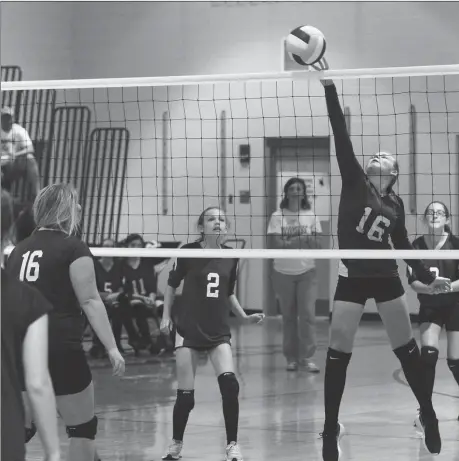  ??  ?? Rossville's Olivia Guest hits a shot toward Chattanoog­a Valley's Lexi Phillips as Rossville's Josie Crowder (2) keeps her eye on the ball. The Lady Bulldogs pushed the Lady Eagles to three sets before home team scored a North Georgia Athletic...