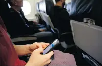  ?? MATT SLOCUM/ THE ASSOCIATED PRESS FILES ?? A decision by the FAA to allow plane passengers to use small electronic devices during takeoffs and landings is being challenged.