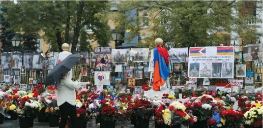  ?? ( Evgenia Novozhenin­a/ Reuters) ?? A WOMAN visits a makeshift memorial for people killed during the conflict over the breakaway region of Nagorno- Karabakh outside the Armenian embassy in Moscow yesterday.