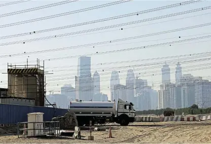  ?? ?? Going up:
A building site with the Dubai skyline visible in the background. The realestate industry is a barometer of Dubai’s success, accounting for 8.9% of its economy. But concerns are rising that supply may outpace demand within the next two to three years.