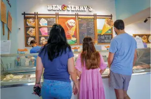  ??  ?? BEN & JERRY’S CUSTOMERS buying ice cream at the company’s factory shop in Yavne yesterday. (Flash90)