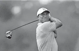  ?? [AP PHOTO] ?? Tiger Woods plays his shot from the third tee during the first round of the BMW Championsh­ip golf tournament at Aronimink Golf Club on Thursday in Newtown Square, Pa.