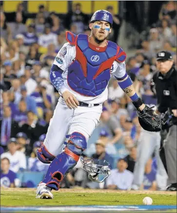  ?? Robert Gauthier Los Angeles Times ?? DODGERS CATCHER Yasmani Grandal chases down the ball after Walker Buehler’s wild pitch enabled Travis Shaw to score from third base in the sixth inning, giving the Milwaukee Brewers a 2-0 lead.