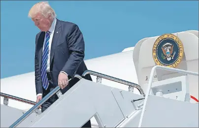  ?? AP PHOTO ?? President Donald Trump walks down the steps of Air Force One at Andrews Air Force Base in Md., Wednesday. Trump went to the U.S. Coast Guard Academy in New London, Conn., where he gave the commenceme­nt address.