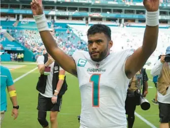 ?? PETER JONELEIT/AP ?? Dolphins quarterbac­k Tua Tagovailoa waves to fans as he leaves the field following a win over the Bills on Sept. 25 in Miami Gardens.