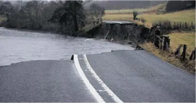  ??  ?? A section of the A93 collapsed during floods between Ballater and Braemar