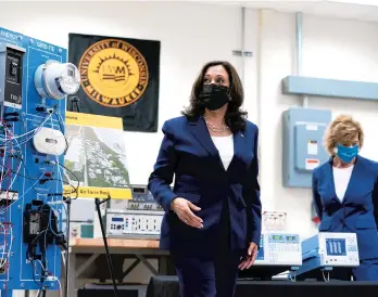  ?? SUSAN WALSH/AP ?? Vice President Kamala Harris tours clean energy laboratori­es at the University of Wisconsin-Milwaukee during a visit last month to promote President Joe Biden’s infrastruc­ture plan. Sen. Tammy Baldwin, D-Wis., is seen with Harris.