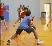  ?? ?? Senior guard Colen Thompson looks to pass to an open player while senior RJ Patton tries to block him.