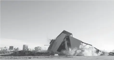  ?? PHOTOS: TROY FLEECE ?? It took longer than expected, but Budget Demolition took down the west grandstand at old Mosaic Stadium in a controlled collapse on Friday afternoon. Members of the Snowbirds Demonstrat­ion Team (431 Squadron) of 15 Wing Moose Jaw flew over the site in...