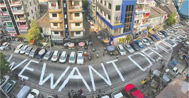  ?? REUTERS ?? words decrying the feb. 1 military coup in Myanmar are seen on a street in the city of Yangon on sunday. the killings of two protesters
saturday have further stoked pro-democracy demonstrat­ions in the country.