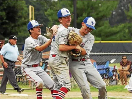  ?? STAN HUDY — SHUDY@DIGITALFIR­STMEDIA.COM ?? Spring Baseball Cal Ripken 12U pitcher Austin Francis (center) is mobbed by teammates Mike Kennedy (right) and Andrew Dongelewic (left) after winning the Mid-Atlantic Regional and earning a berth in the World Series.