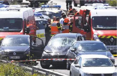  ?? Associated Press ?? Security forces surround a car (center) that authoritie­s say was used in an attack on soldiers near Paris.