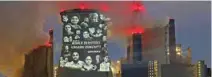  ?? - Reuters ?? PROTEST: Activists of the environmen­tal organisati­on Greenpeace project a slogan that reads No Future in Fossil Fuels” on the cooling tower of RWE coal power plant, one of Europe’s biggest electricit­y companies in Neurath, north-west of Cologne,...