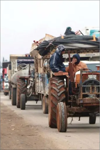  ?? Foto: Mahmoud Hassano, Reuters/NTB scanpix ?? Lastebiler og traktorer frakter eiendelene til folk som flykter fra krigføring­en i Idlib den 24. desember.