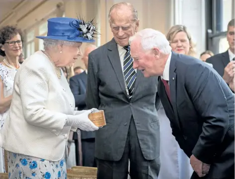  ?? STEFAN ROUSSEAU/GETTY IMAGES ?? Britain’s Queen Elizabeth II, accompanie­d by Prince Philip, Duke of Edinburgh, is welcomed by Canadian Governor General David Johnston on a visit to Canada House in central London on Wednesday to mark the 150th anniversar­y of Confederat­ion.