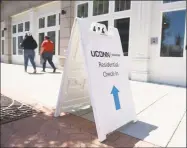  ?? Tyler Sizemore / Hearst Connecticu­t Media ?? A sign leads to check-in for the student dorms at the UConn Stamford branch on Monday.