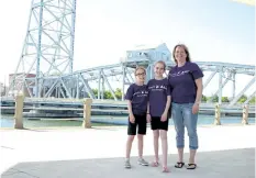  ?? LAURA BARTON/POSTMEDIA NEWS ?? Rachel Veldhuizen, centre, her mother Laureli and younger sister Taylor are ready for Welland’s Main Street Bridge and other Niagara landmarks to be lit purple tonight to create awareness for inflammato­ry bowel diseases such as ulcerative colitis,...