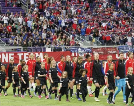  ?? ASSOCIATED PRESS FILE ?? The United States women’s national team walks out with youth soccer players for a friendly against Switzerlan­d on Oct. 23, 2016, in Minneapoli­s.