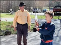  ??  ?? LEFT: Trout Unlimited volunteer Bill Pinson (left) watches his grandson Ezra Pinson practice his flycasting technique at the Trout Unlimited Expo on Saturday.