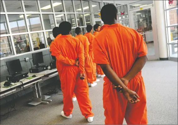  ?? (File Photo/The Shreveport Times/Val Horvath) ?? Teenagers head toward the gym in July 2010 at Caddo Juvenile Detention Center in Shreveport, La. Fear and frustratio­n is raging as fast as the coronaviru­s in some juvenile detention centers, with riots and escapes reported in hot-spot facilities such as New York and Louisiana.