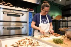  ?? ?? Erika Bruce of Squirrel Hill, one of the co-owners of the new Third Space Bakery, slices mushrooms for quiche.