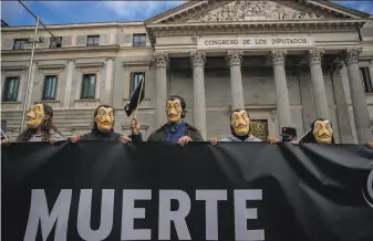  ?? Manu Fernandez / Associated Press ?? Protesters hold a banner saying “Death” against legalizing euthanasia in Madrid. Euthanasia is legal in Belgium, Canada, Colombia, Luxembourg, the Netherland­s, Portugal and Switzerlan­d.