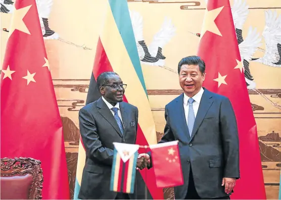  ?? Picture: REUTERS ?? HANDOVER: Zimbabwean President Robert Mugabe and China’s Xi Jinping shake hands during a signing ceremony at the Great Hall of the People in Beijing last year