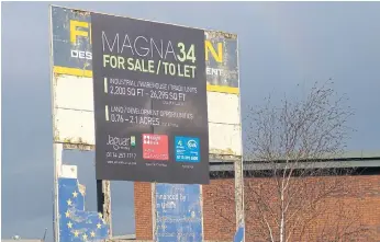  ??  ?? NO GOING BACK: A new sign offering industrial units and land for sale is pictured on top of a crumbling sign showing a European flag and ‘Financed by the European Union’ signage in Rotherham.