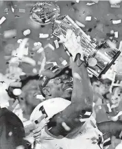  ?? [PHOTO BY NATE BILLINGS, THE OKLAHOMAN] ?? Georgia running back Sony Michel raises the Leishman Trophy after helping the Bulldogs beat Oklahoma in double overtime on Monday night at the Rose Bowl.