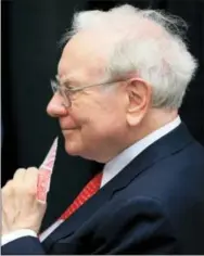  ?? NATI HARNIK — THE ASSOCIATED PRESS FILE ?? In this Sunday file photo, Berkshire Hathaway Chairman and CEO Warren Buffett plays bridge outside the Borsheims jewelry store, a Berkshire Hathaway subsidiary, in Omaha, Neb. Buffett has a high-class problem: cash is piling up at Berkshire Hathaway...