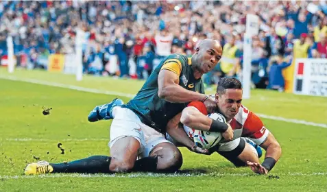  ?? Photo: REUTERS ?? Karne Hesketh, pictured here scoring his match-winning try against the Springboks, is just one of 40NewZeala­nd-born players playing for other nations at the World Cup.