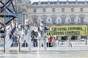  ?? REUTERS ?? Greenpeace activists during a protest in Paris on Wednesday amid calls for a law that bans fossil fuel advertisin­g and sponsorshi­p in the EU.