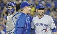 ?? TED S. WARREN / THE ASSOCIATED PRESS ?? Toronto Blue Jays manager John Gibbons, centre, smiles as he talks to starting pitcher Marco Estrada, who has been a key part of a Blue Jays rotation.