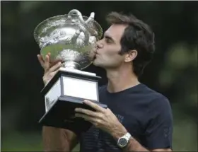  ?? DITA ALANGKARA — ASSOCIATED PRESS ?? Roger Federer kisses the Norman Brookes Challenge Cup after winning the Australian Open.