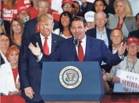  ?? BUTCH DILL/AP ?? Then-President Donald Trump with Ron DeSantis, then a candidate for Florida governor, at a rally in 2018. Trump takes credit for DeSantis’ win.