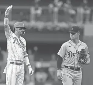  ?? MITCHELL LEFF/GETTY IMAGES ?? Nick Castellano­s of the Phillies reacts in front of Spencer Torkelson of the Tigers after hitting an RBI double in the second inning at Citizens Bank Park.